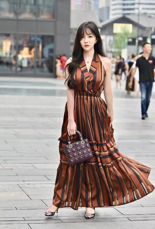 小姐姐搭配了一双尖头的高跟鞋，和一个小方包，看起来格外有韵味