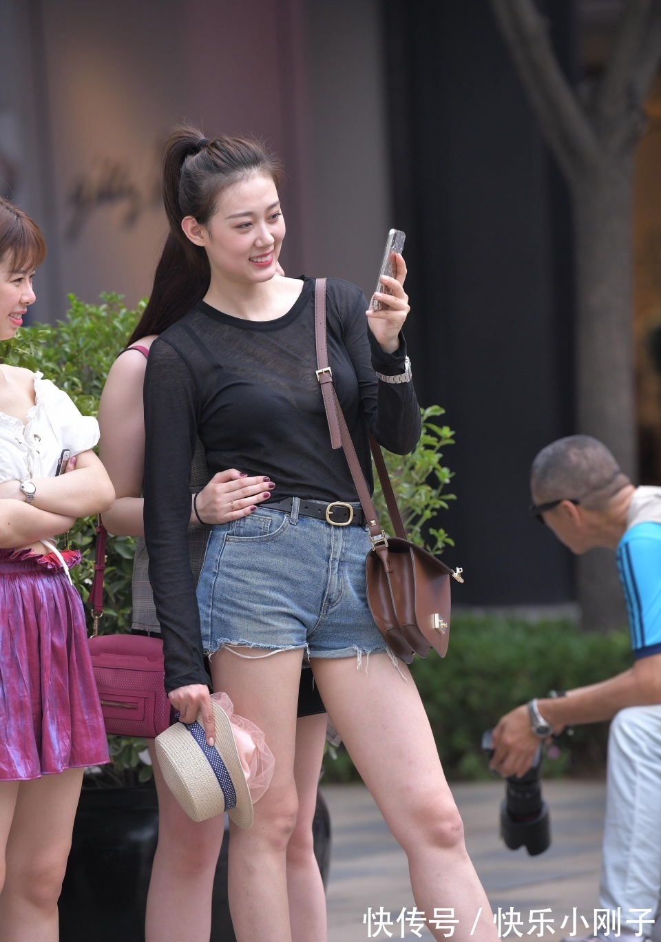 高女孩|小姐姐身穿黑色的长袖,搭配黑色的牛仔短裤,走在街上很时尚大方