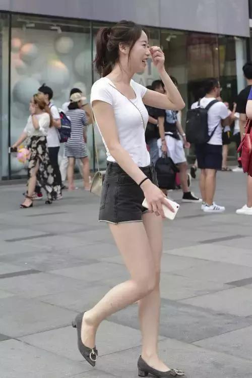 牛仔|街拍小姐姐黑色露肩上衣搭配一条紧致的牛仔短裤,很有少女范