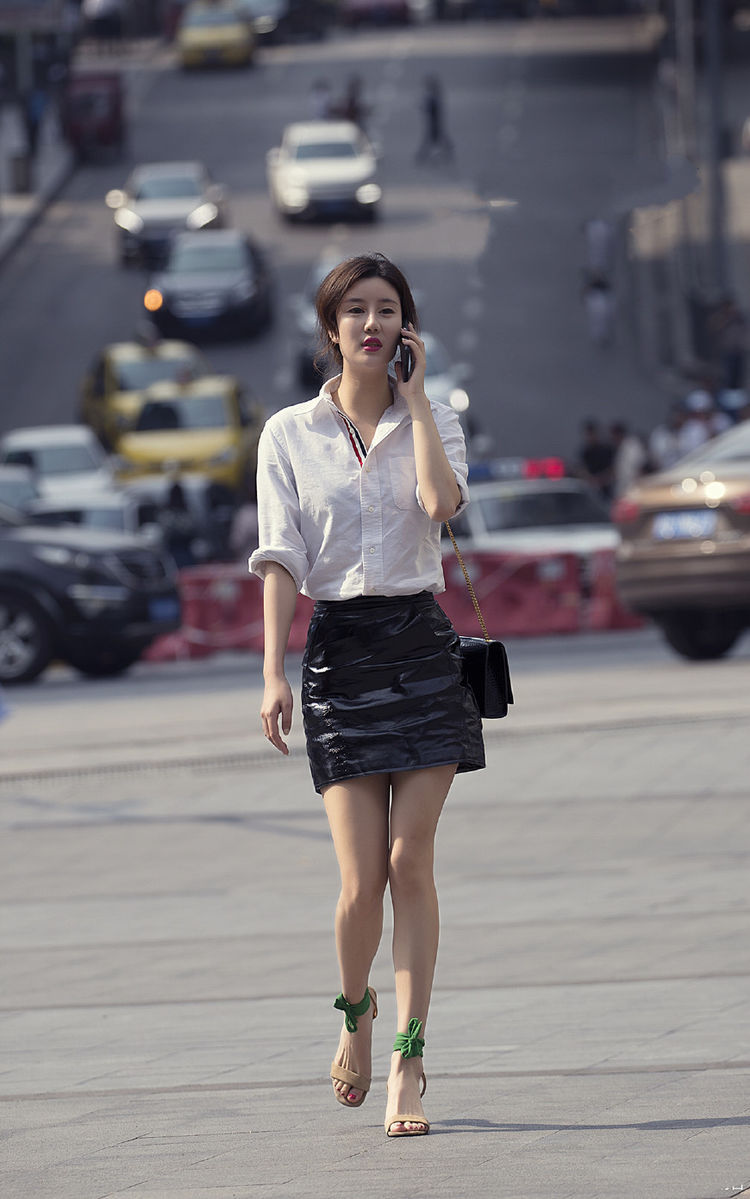 街拍:美女白色衬衫搭配黑色皮裙,脚踩一双高跟鞋,非常有气质!