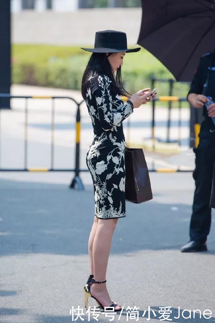 美女脚上踩着一双红色高跟凉鞋，带有绒毛的设计看上去温柔又时尚