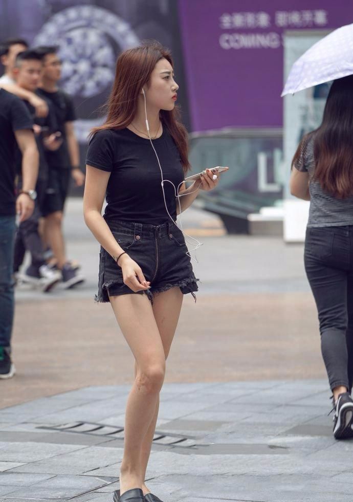 街拍:美女上身穿黑色t恤,下身搭配潮流短裤,焕发出简约的魅力