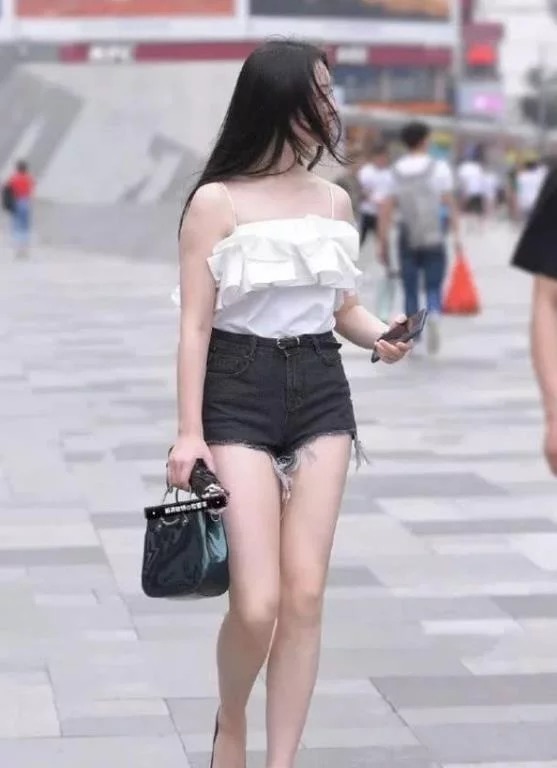 街拍:艳冶柔媚的小姐姐,身穿长款上衣配短裤,笑容甜美可爱