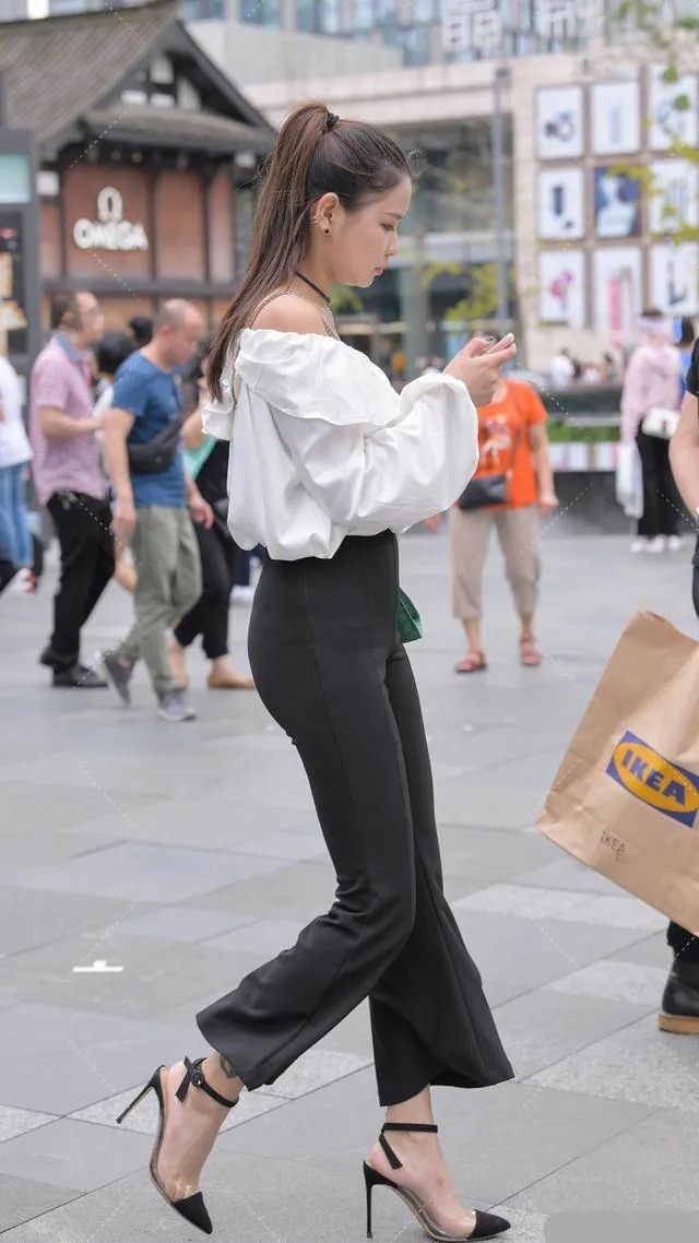 喇叭裤 皮肤白皙的美女,一件白色露肩上衣搭配黑色喇叭裤穿搭出众显贵气