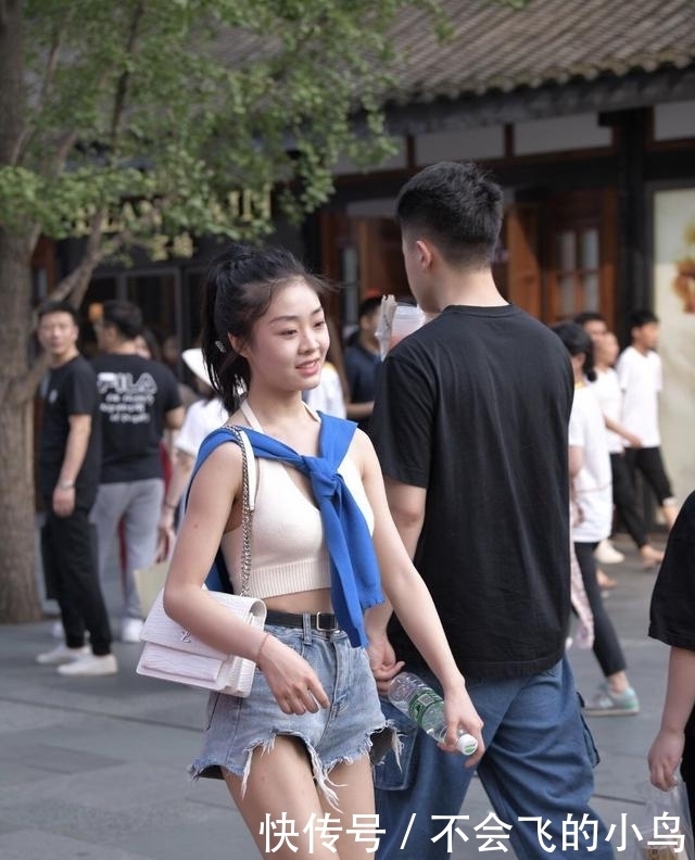 街头美女的另类造型，穿“露脐背心”秀身材，却把外套当“围巾”