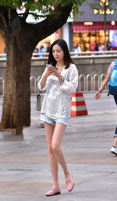 舒适|街拍小姐姐一件黑色半袖上衣宽松舒适,搭配白色短裤显得休闲风