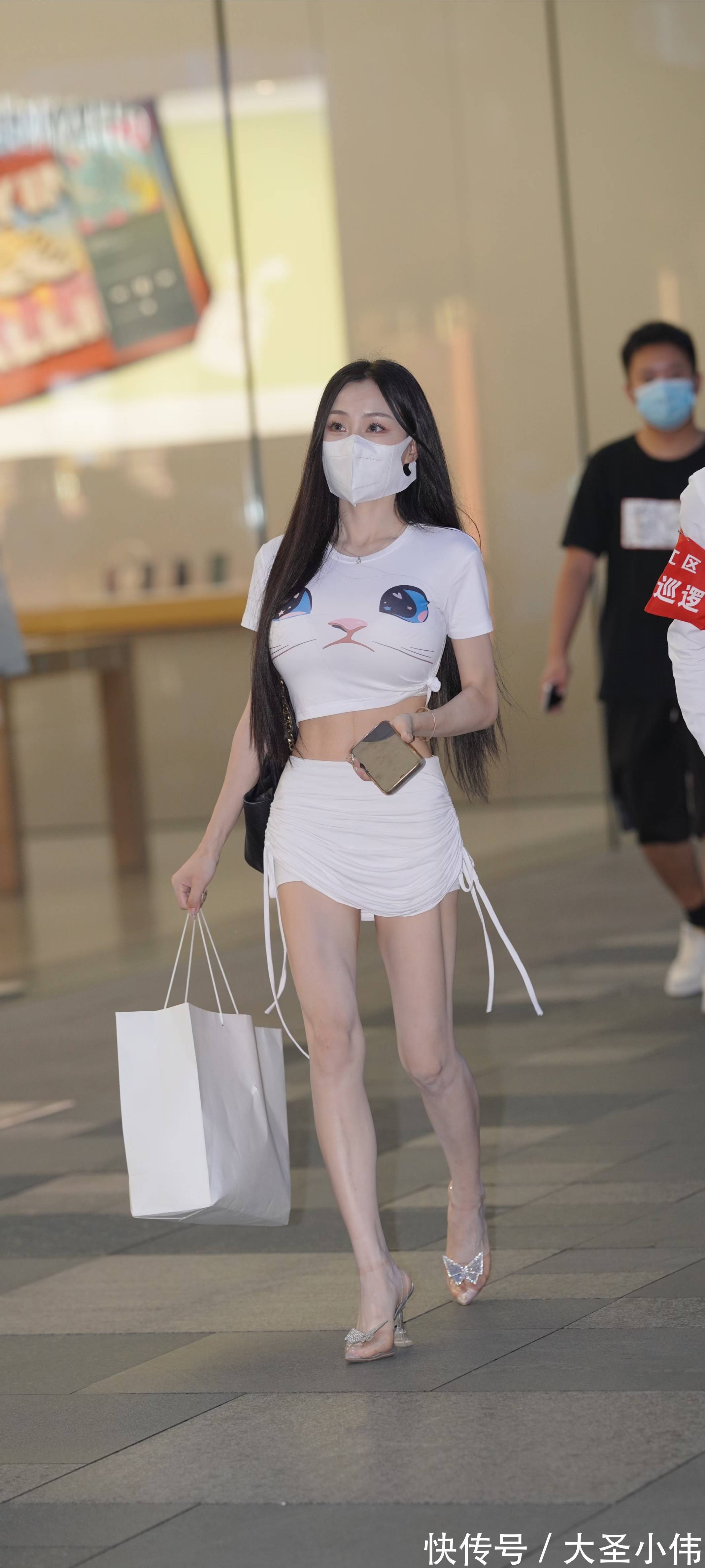 小姐姐 美女街拍:猫咪图案的白T恤很萌,抽绳包臀裙很显身材,小姐姐轻松成为了焦点