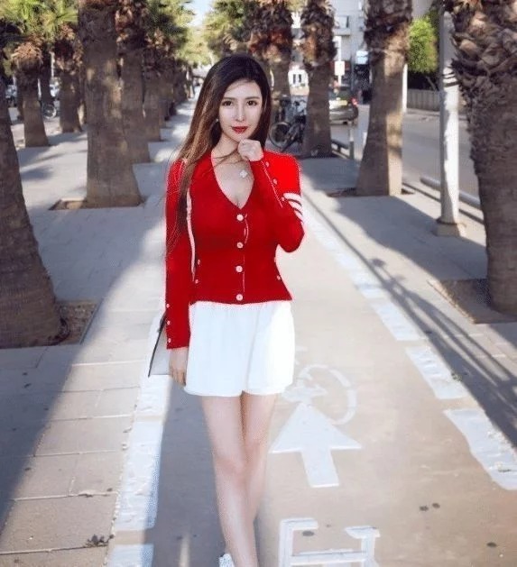 街拍:长长的秀发飘在空中,一身红色的外套十分亮眼,很漂亮