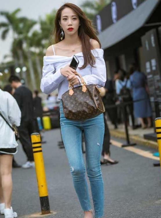 身材高挑|街拍：身材高挑的美女，一件白色一字肩配蓝色牛仔裤，都市丽人范