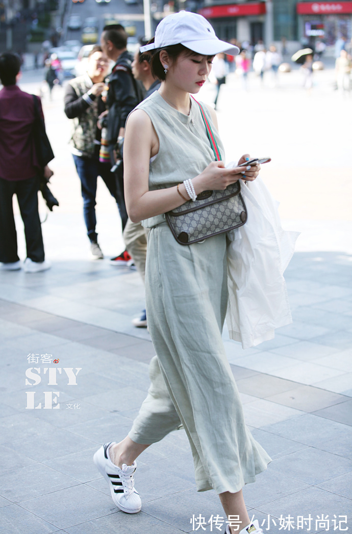 牛仔背带裤|重庆街拍,浅黄色T恤搭配牛仔背带裤,彰显温暖可爱又迷人