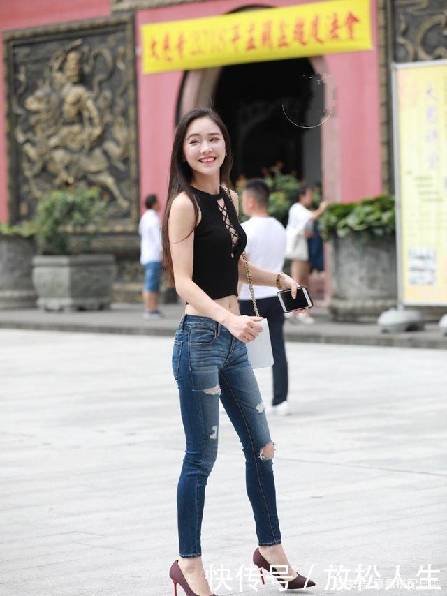 小姐姐一件黑色背心,搭配一条破洞牛仔裤,时尚大方有个性