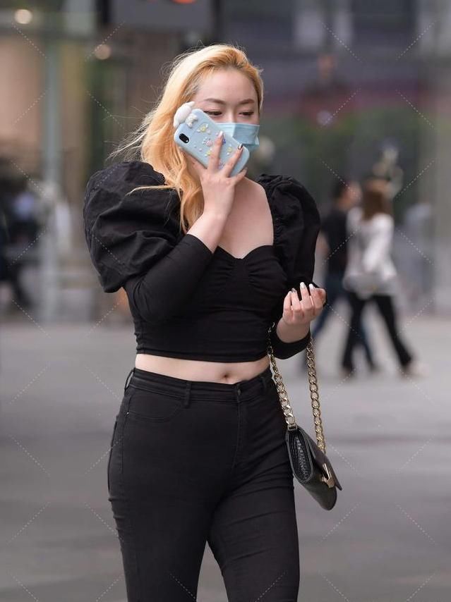 黑领口上衣，宽松的袖口设计，与同色牛仔裤相配，展现别样气质