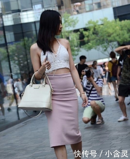 街拍美女身穿极简吊带露背上衣,配粉红紧身裙,优雅自信