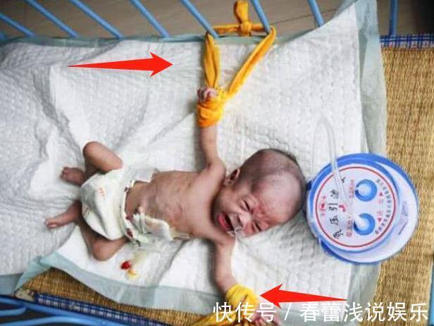 孩子|刚出生女婴被妈妈五花大绑,躺在床上不能动弹,父亲在一边抹泪
