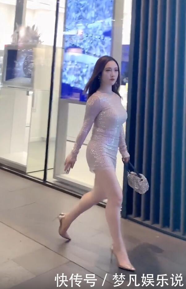 打扮精致的街头美女,泛光短裙配尖嘴高跟,时尚有个性