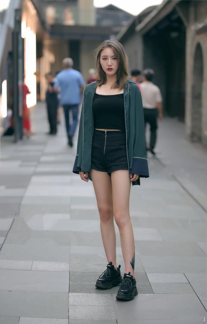 热裤 小姐姐身穿挂脖上衣,搭配牛仔热裤,发型做更很时尚