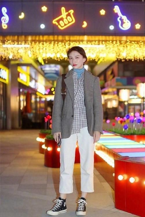 路人街拍，肩上挎着一个白色单肩桶包，凸显了美女干净的外形