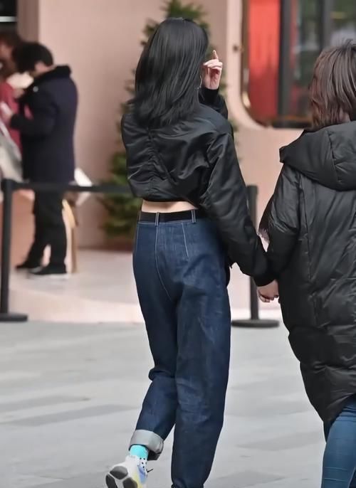 街拍美女黑衣蓝裤的小姐姐好帅气,抬脚就被“猫印鞋”抢镜了