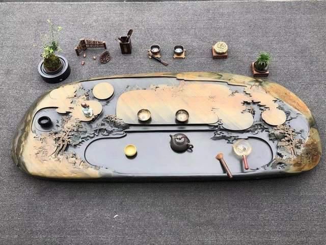 真正的“难得一见”,把长近2米的石头刻成山水画,还制成了茶盘