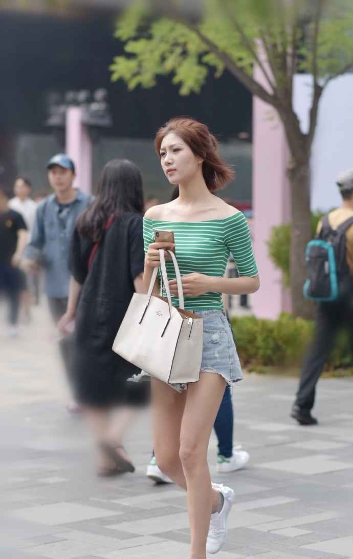 街拍:穿着白色上衣的美女,搭配牛仔短裤,长发及腰尽显女神气质