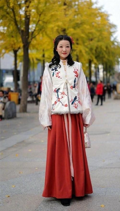 路人街拍，肩上挎着一个白色单肩桶包，凸显了美女干净的外形