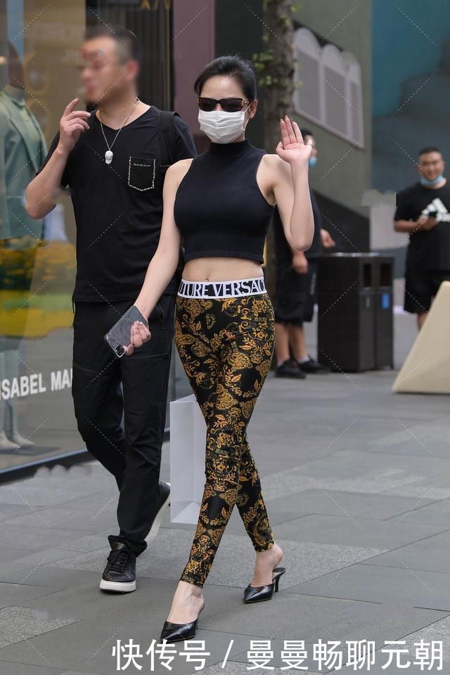 阿姨黑色半高领上衣搭配花纹修身裤,设计精美,尽显时髦气息