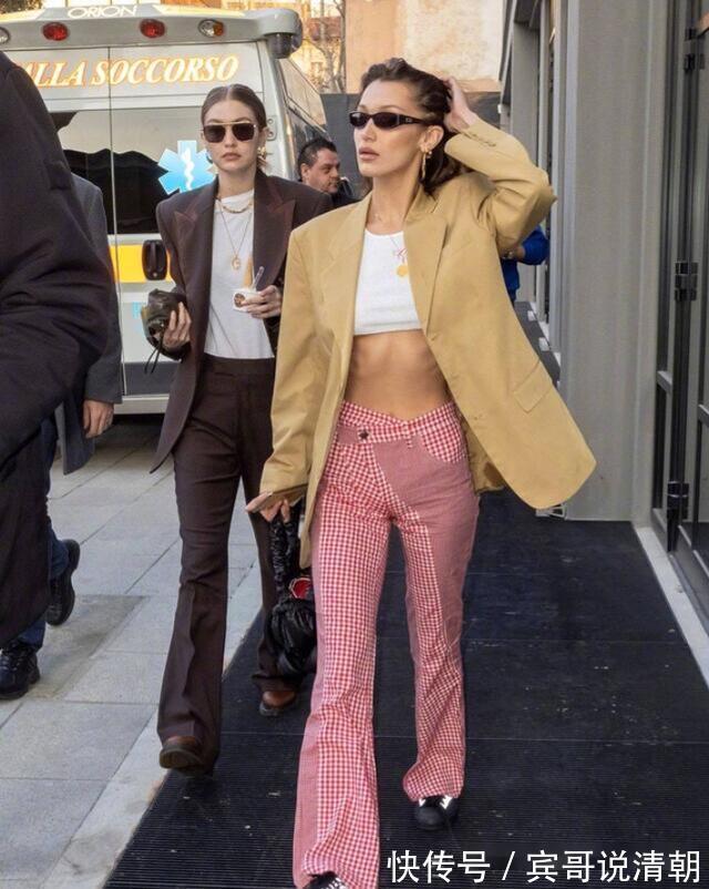 吊带上衣|街拍,美女穿白色高腰款式的吊带上衣,更显娇俏动人