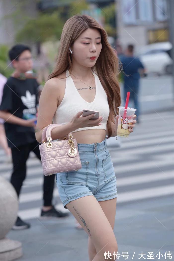 黄金比例|美女街拍:白色挂脖式针织上衣,搭配牛仔短裤和小白鞋,时尚性感又减龄好看