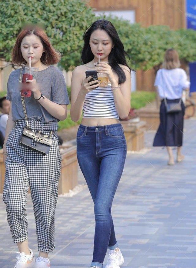 一套条纹胸衣吸引了路人的眼球，而经典的高腰牛仔裤则突出了长腿