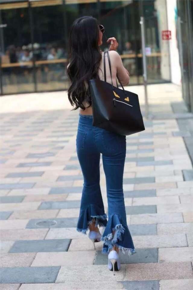 美女|街拍美女:牛仔裤穿出特色,裤脚“开花”,美得不像话