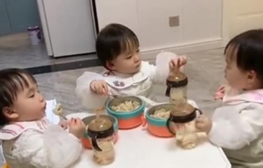 家长们|三胞胎吃饭时一个“碰杯”的举动萌翻众人,网友:军事化管理的好