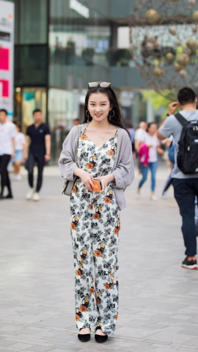 街拍:小姐姐身穿红色无袖上衣,白色的长裤,造型很时尚