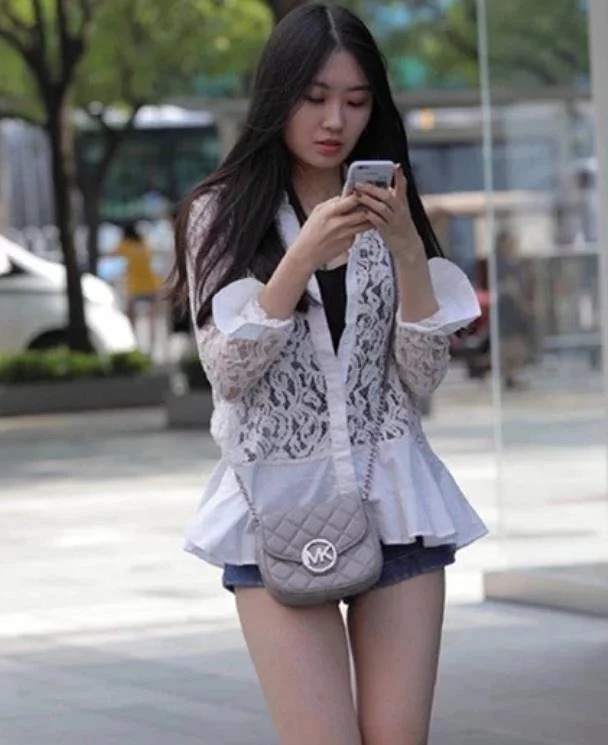 街拍：活泼可爱的小美女，身穿吊带蕾丝裙，很显洋气