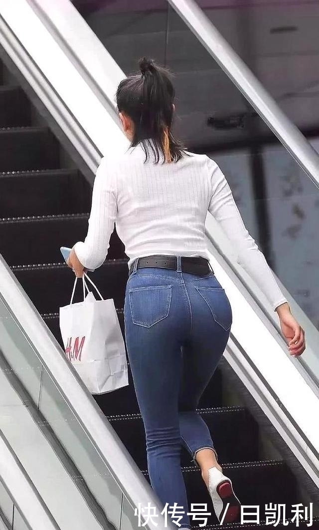 小姐姐穿简约的牛仔裤，配上白色吊带，青春时尚气息十足