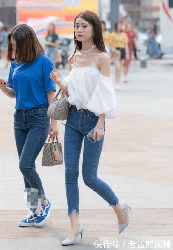 紧身牛仔裤|街拍美女:小姐姐一身白色上衣,搭配紧身牛仔裤,轻熟气息挡不住