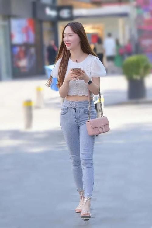 白色充满少女感的短袖上衣，搭配修身长牛仔裤，穿出魅力十足的美