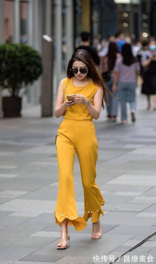 破洞牛仔裤 杏色的针织无袖衫,配高腰的白色雪纺喇叭裤,穿出了身材的美