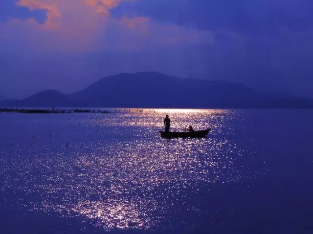 悠然自得|夕阳映照万顷碧波，渔民悠然自得