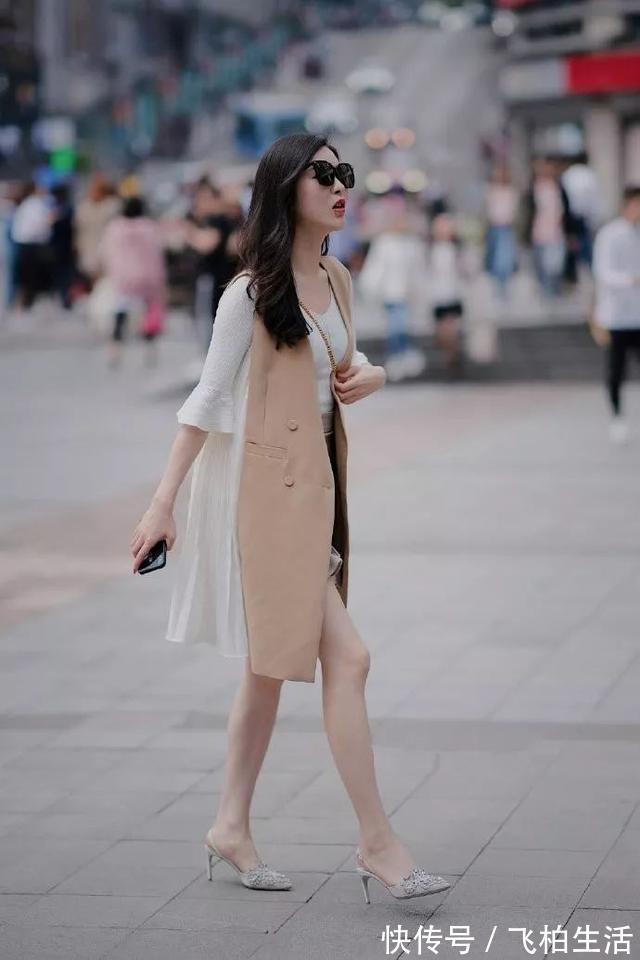 衬衫 小姐姐身穿宽松衬衫,搭配鲜艳的印花半身裙,显得格外的靓丽