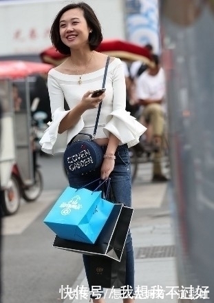 街拍|街拍:紧身牛仔裤搭配白色露肩装的美女,甜美笑容让人印象深刻