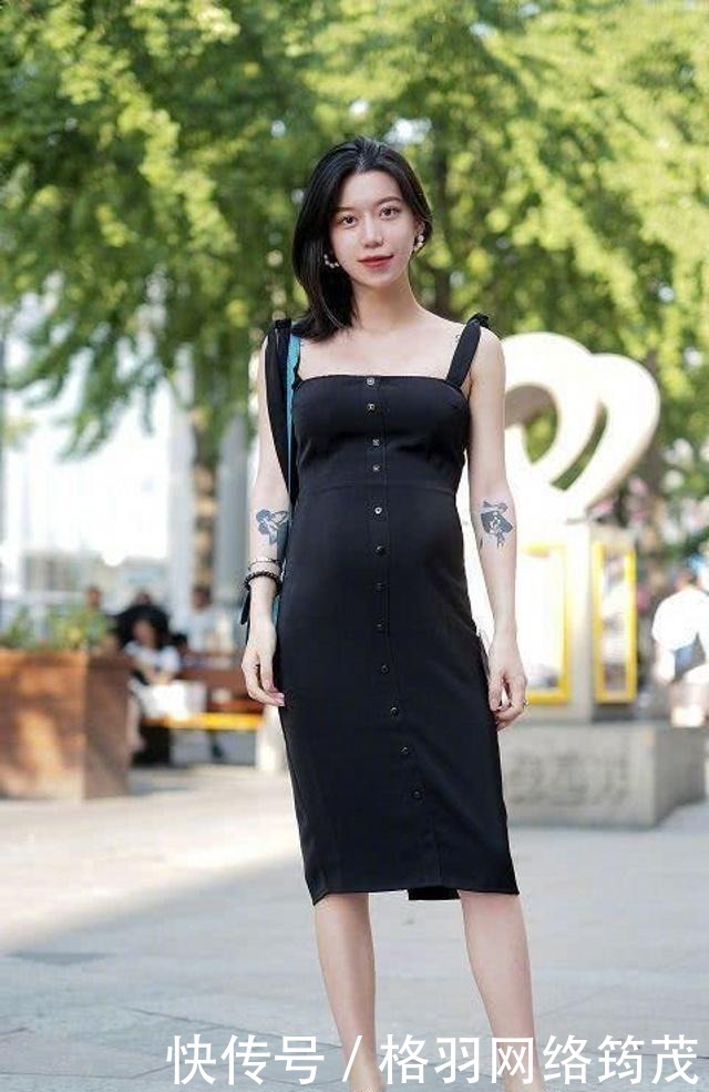 路人街拍,黑色的连衣裙优雅大方,显出一种唯美而又休闲的味道