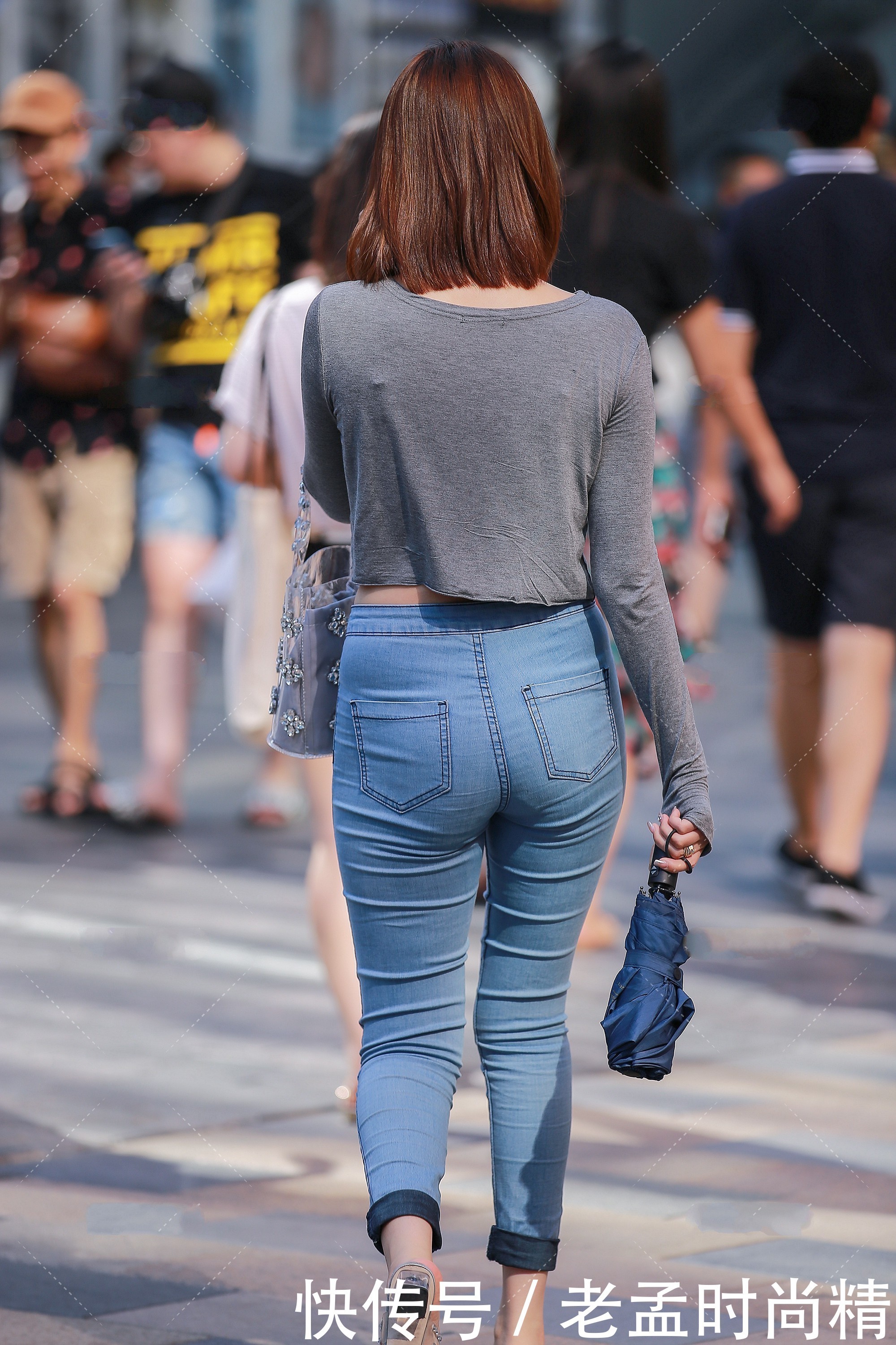 牛仔裤|街拍:灰色短款修身上衣,搭配浅蓝色经典牛仔裤,简约大方又不失时尚