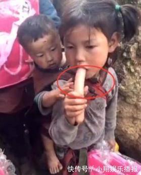 农村|姐姐自己吃香肠,弟弟在后面看着,姐姐的动作很暖心