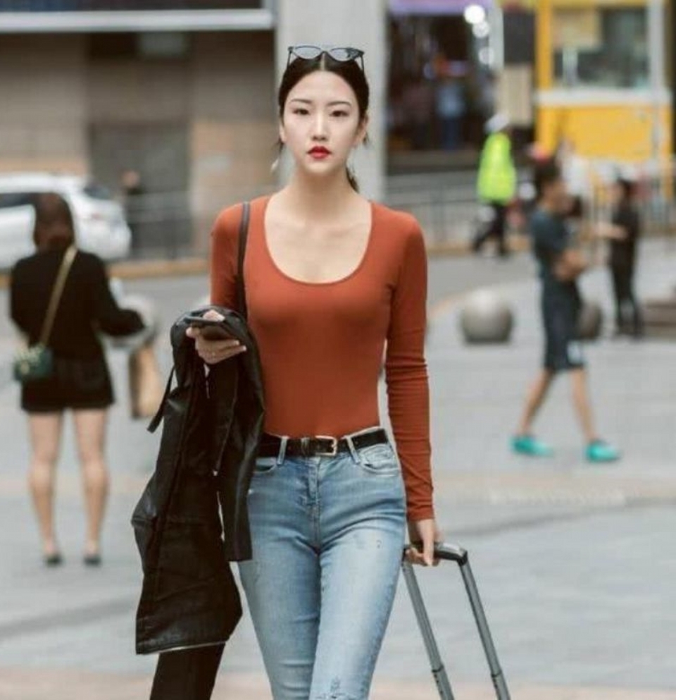 路人街拍,黑色的休闲裤搭配一件小背心,气质时髦感十足